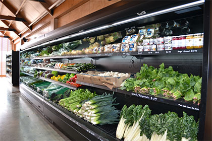 produce on black open multideck in grocery store