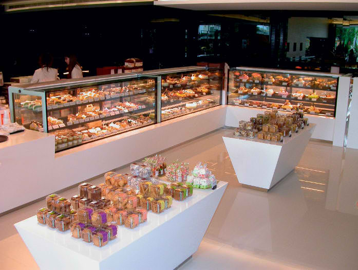 cakes pastries in glass cabinets on countertop