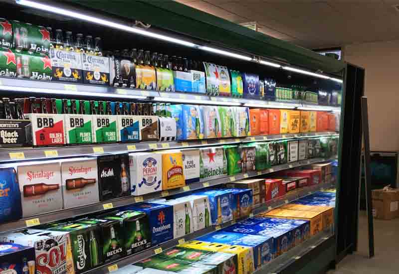 beer displayed on chilled openfront multideck in grocery store