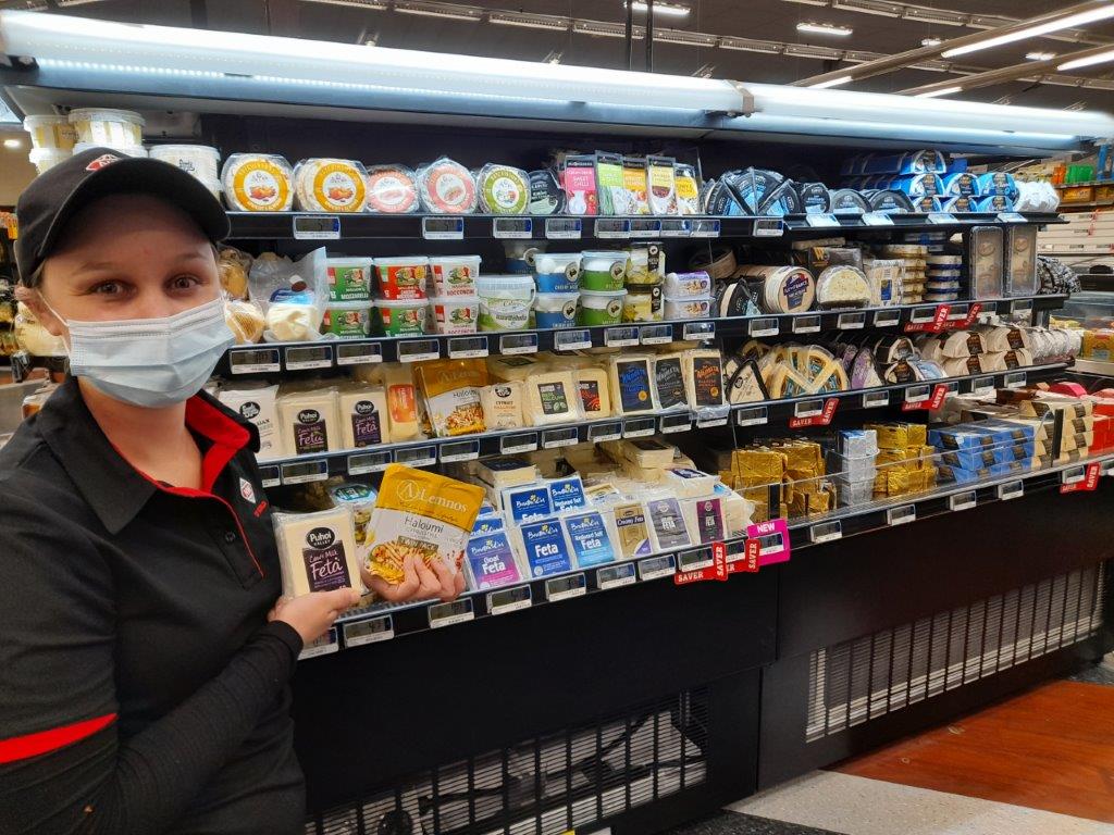 cheese cabinet display in grocery store